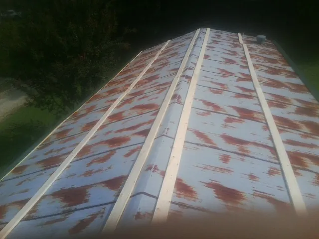 Rusted metal roof panels with new wood purlins before replacement — Storm Damage Roof Repair in Bel Alton by Roofing Brothers