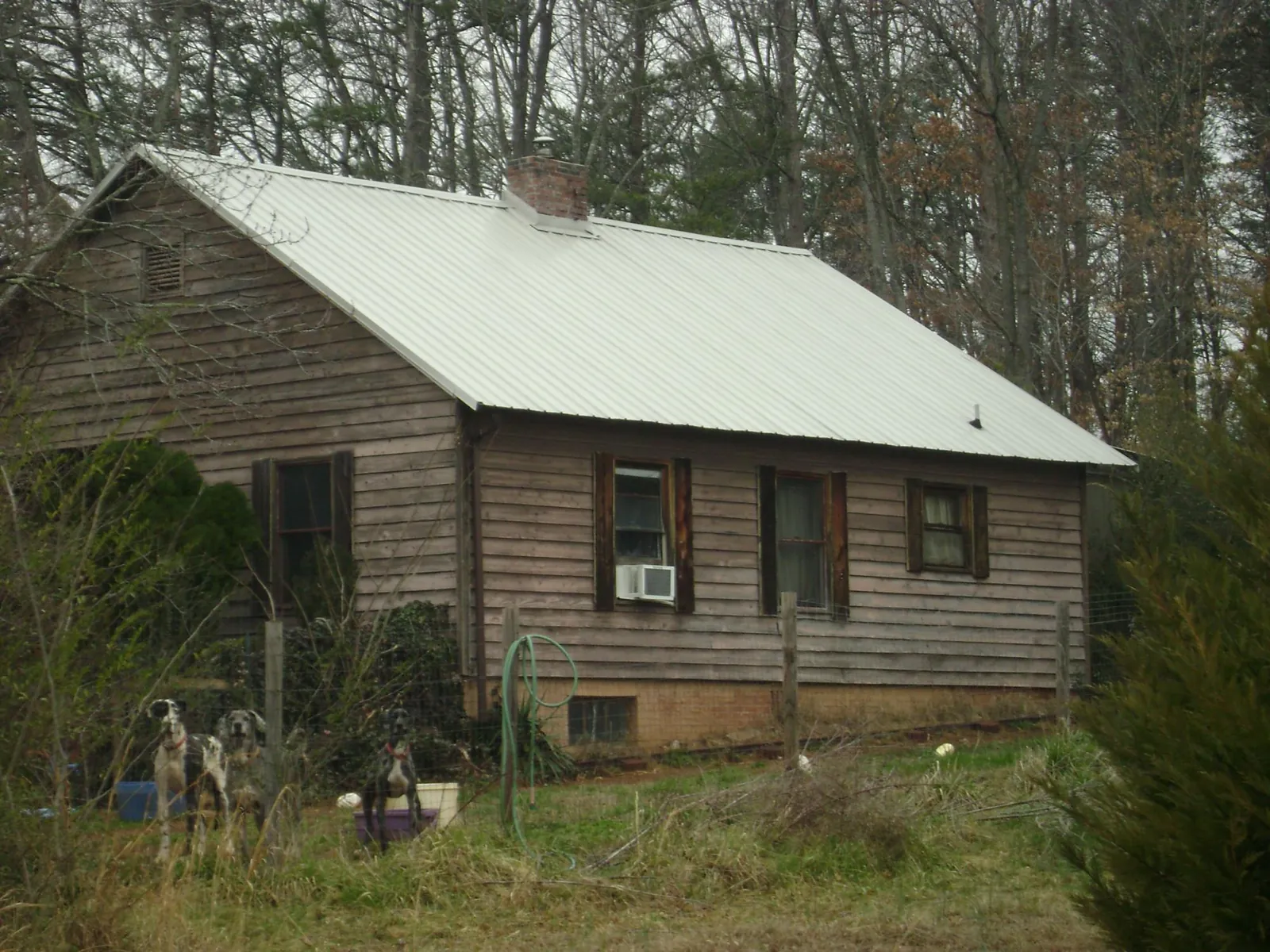 White metal roof on an old wood sided farmhouse, from a Metal Roof Installation job in Bel Alton